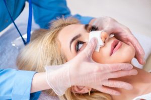 woman with bandage on nose