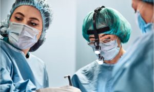 The group of doctors is doing cosmetic surgery.